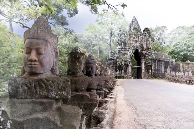 Mythic-statues-line-the-causeway-over-a-moat-leading-to-the-south-gate-of-Angkor-Thom